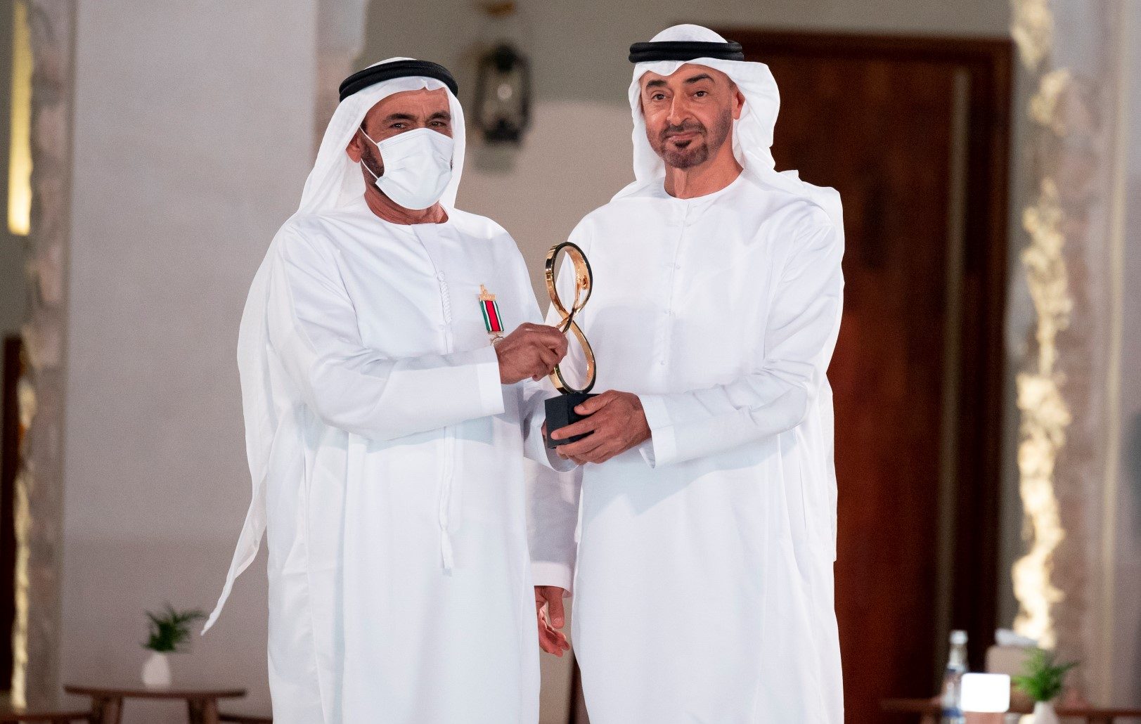 ABU DHABI, UNITED ARAB EMIRATES - April 07, 2021: HH Sheikh Mohamed bin Zayed Al Nahyan, Crown Prince of Abu Dhabi and Deputy Supreme Commander of the UAE Armed Forces (R), presents an Abu Dhabi Award to Lieutenant General (Rtd.) Obaid Mohammed Al Kaabi (L), during an awards ceremony, at Qasr Al Hosn.

( Mohamed Al Hammadi / Ministry of Presidential Affairs )
---