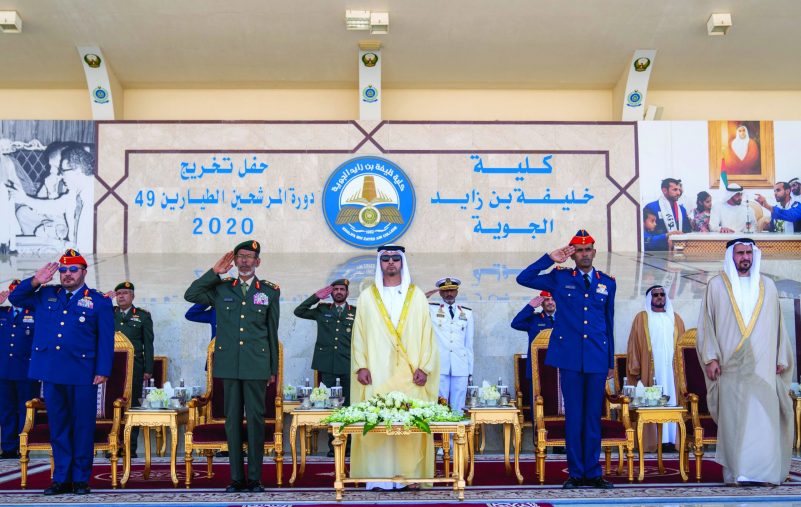 AL AIN, ABU DHABI, UNITED ARAB EMIRATES - March 01, 2020: HH Sheikh Hazza bin Zayed Al Nahyan, Vice Chairman of the Abu Dhabi Executive Council (3rd L), stands for the national anthem during the Khalifa bin Zayed Air College graduation ceremony. Seen with HE Major General Ibrahim Nasser Al Alawi, Commander of the UAE Air Forces and Air Defence (L) and HE Lt General Hamad Thani Al Romaithi, Chief of Staff UAE Armed Forces (2nd L)

( Hamad Al Kaabi  / Ministry of Presidential Affairs )
---